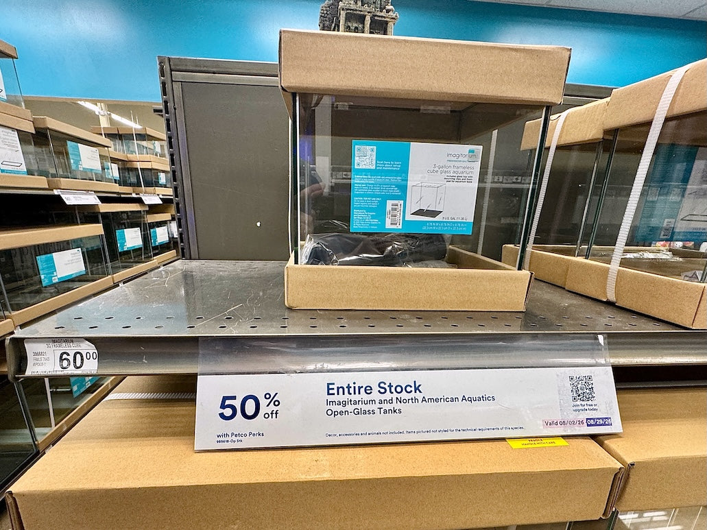Fish Tank With 50% Off Entire Stock Sign