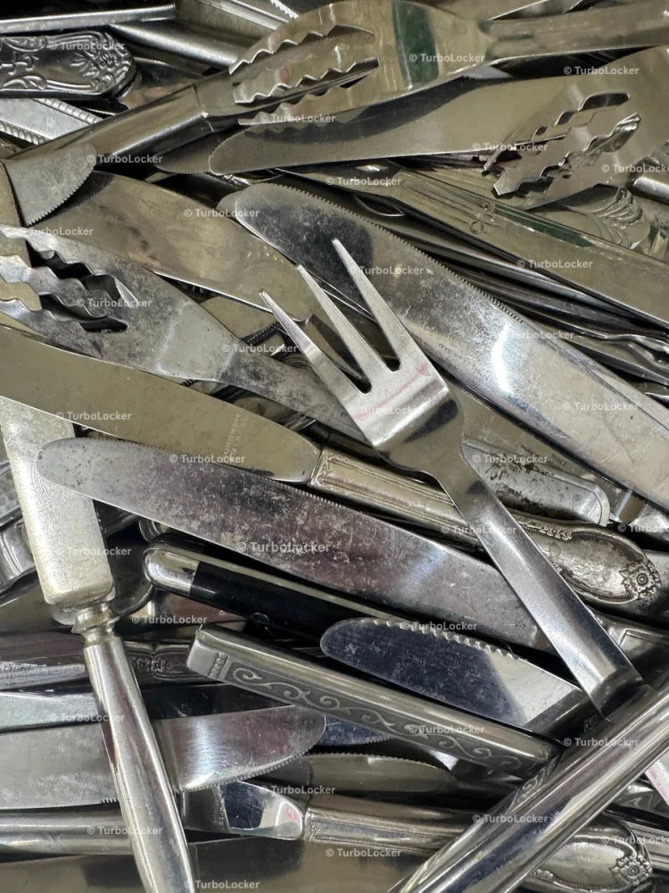 Assorted Worn Stainless Steel Knives And Forks In A Drawer